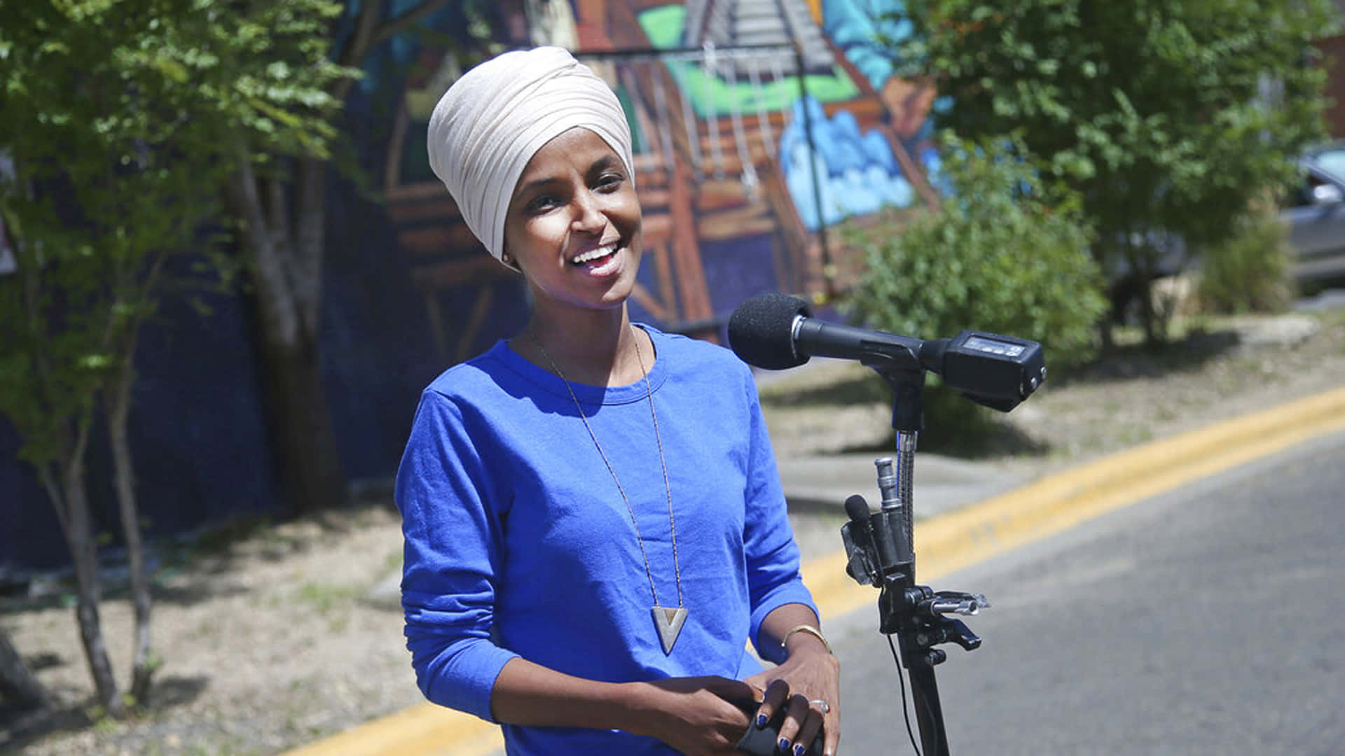 Ilhan Omar Delivering A Speech Wallpaper