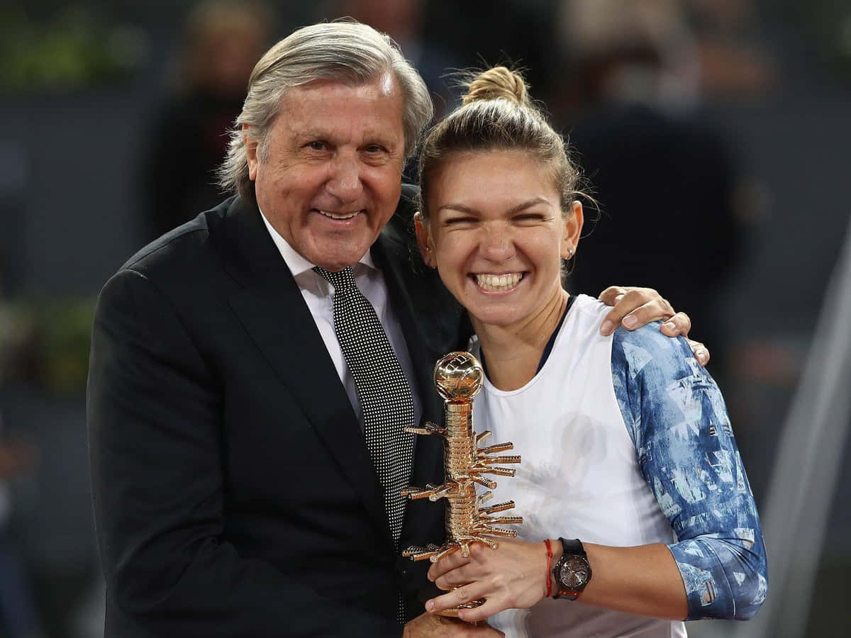 Ilie Năstase cheering for Simona Halep on the tennis court Wallpaper