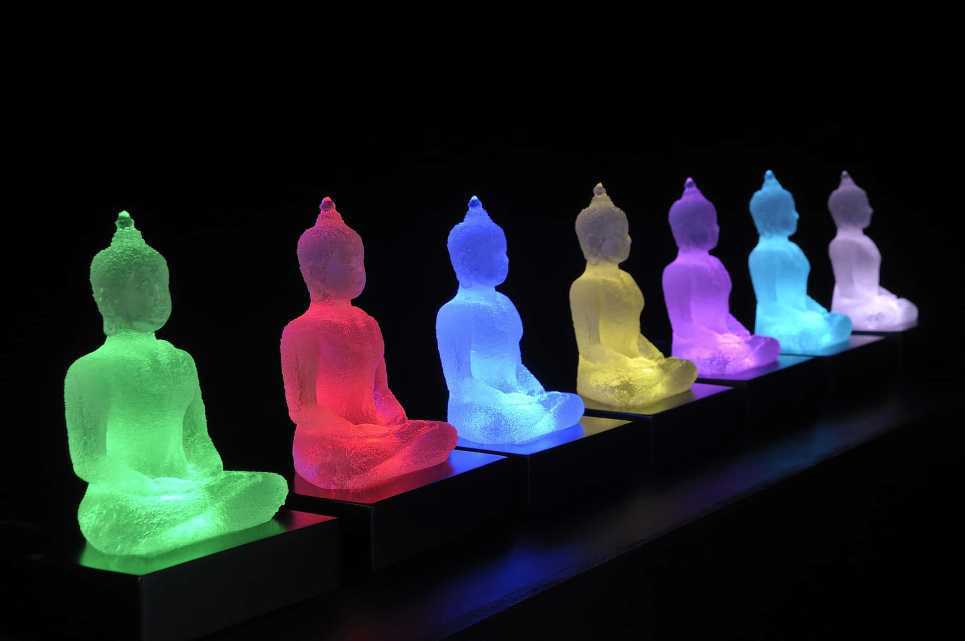 Illuminated Buddha Statuesin Row Wallpaper