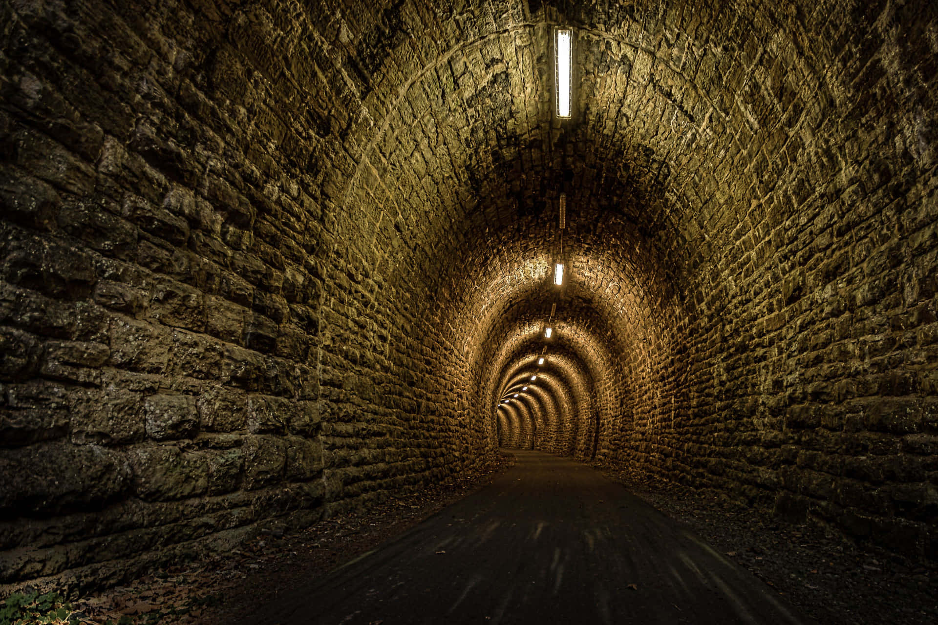 Illuminated Stone Tunnel Pathway Wallpaper