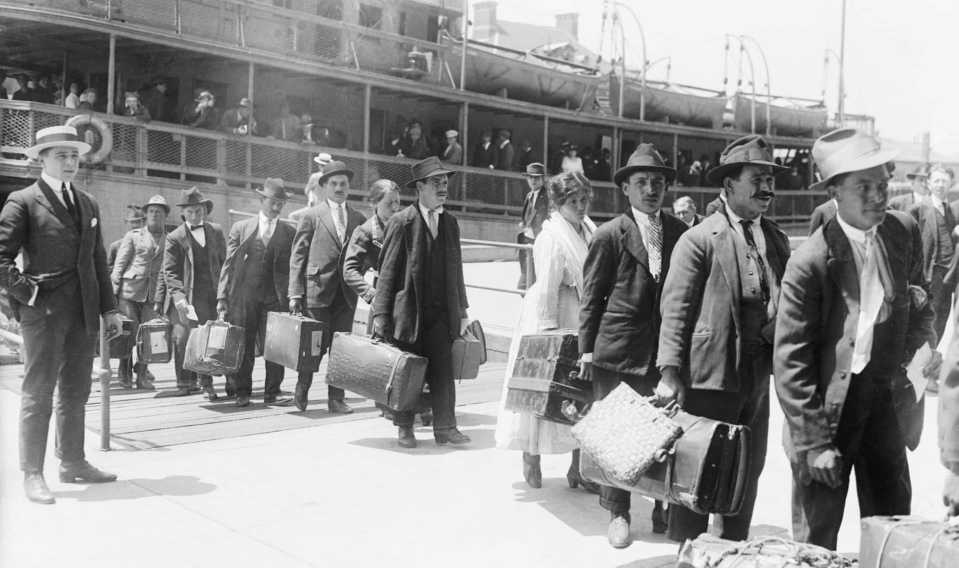A Group Of People Standing On A Dock With Luggage