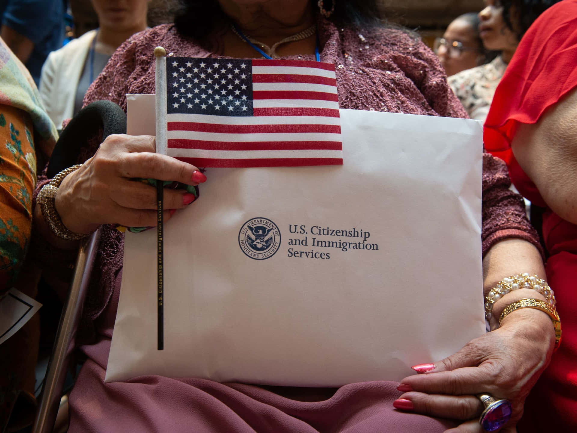 A Woman Holds An American Flag And A Letter