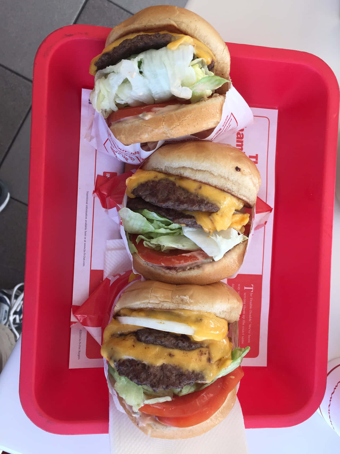 A Red Tray With Three Hamburgers On It Wallpaper