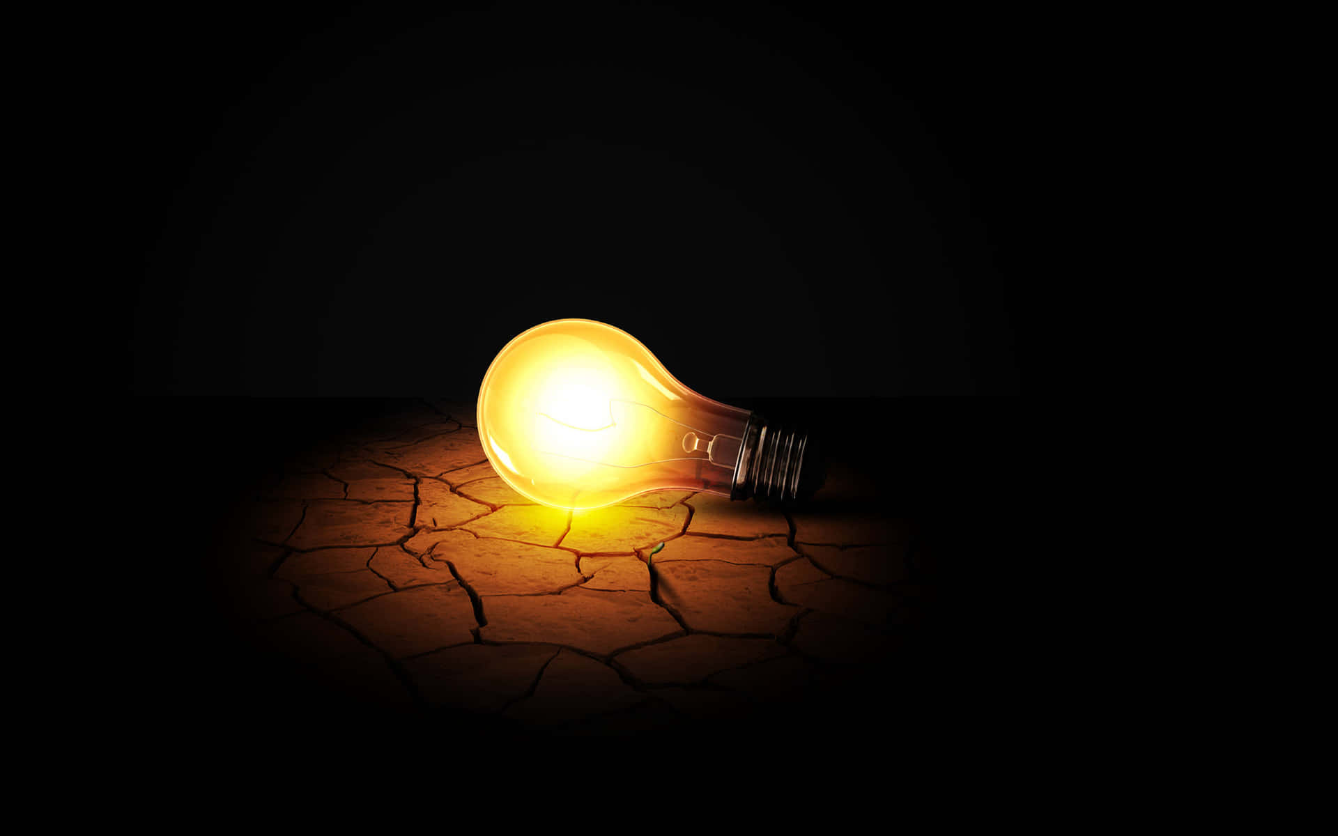 Incandescent Bulb On Cracked Ground Wallpaper