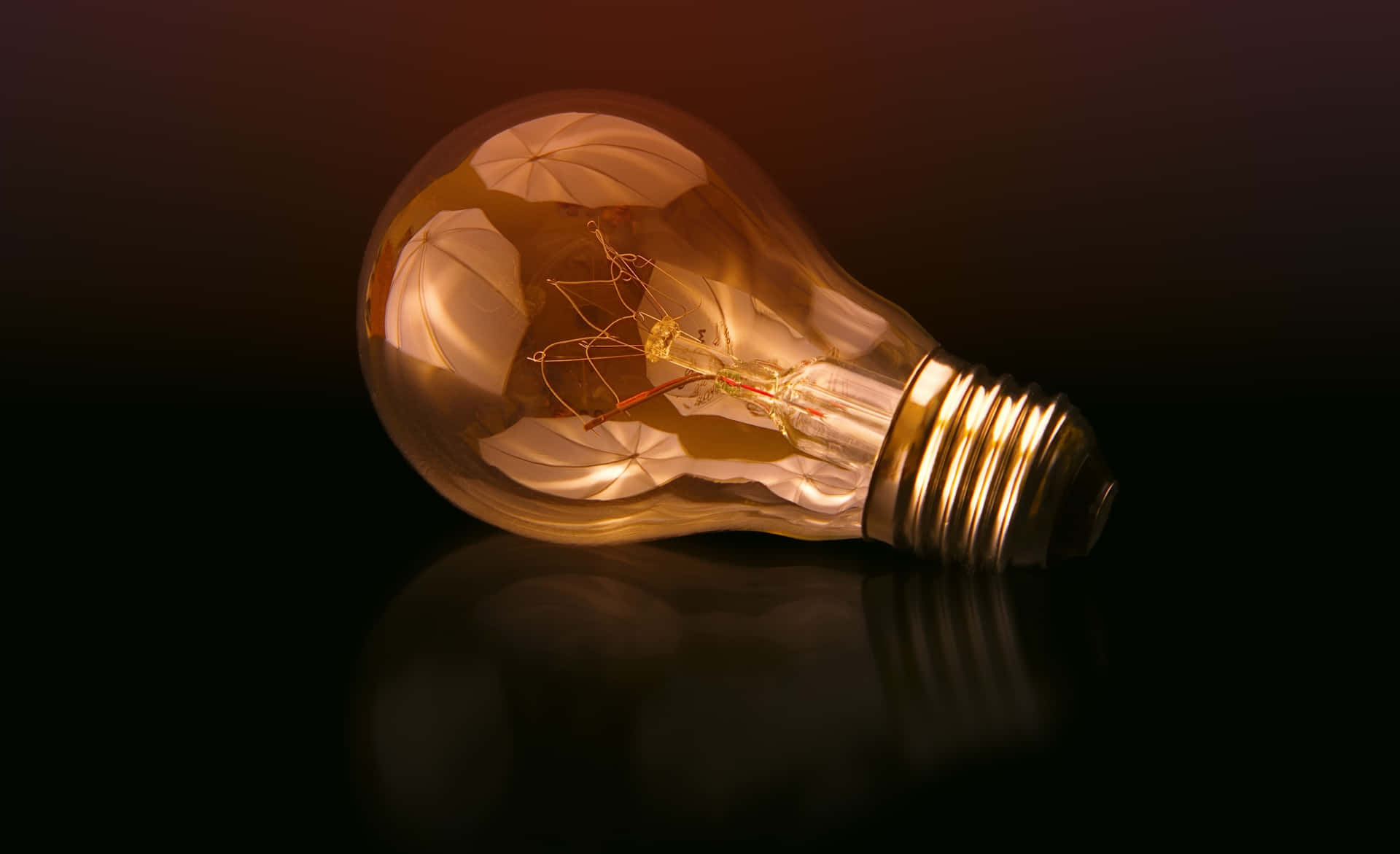 Incandescent Bulb On Maroon Background Wallpaper