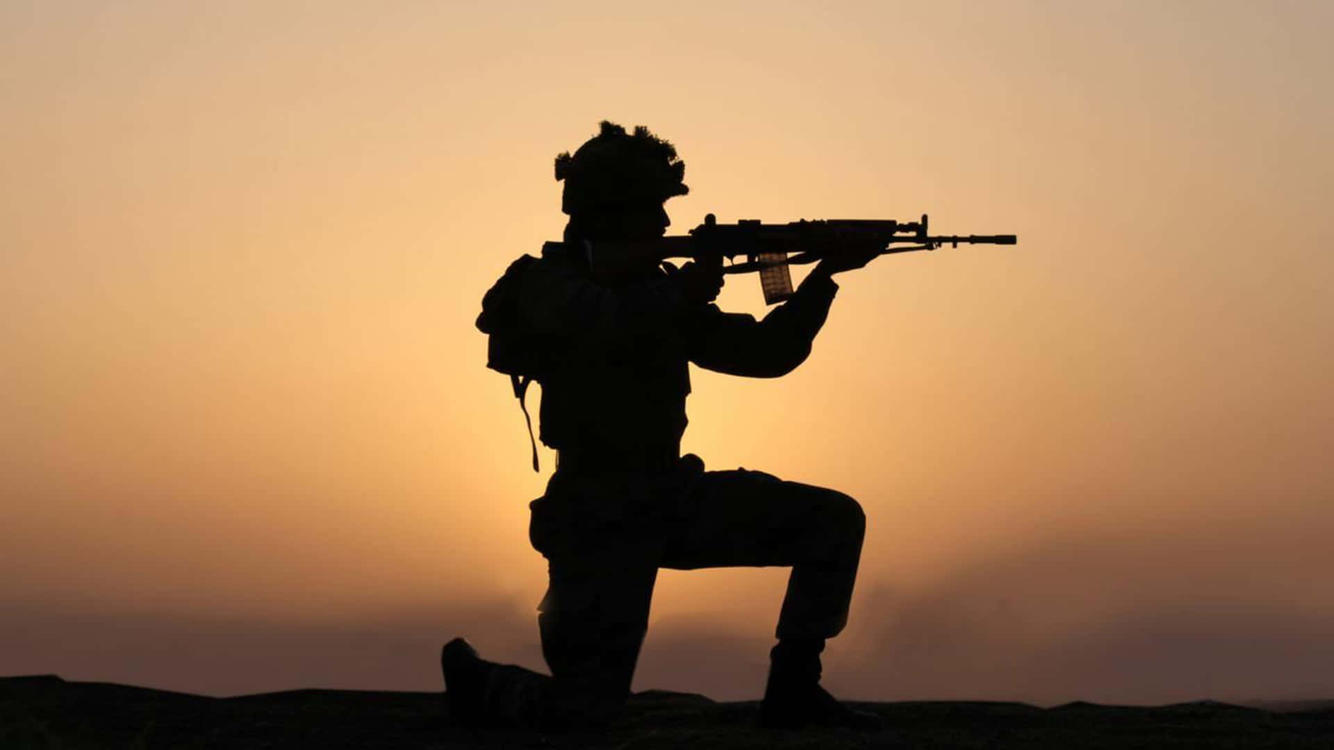 A Soldier Is Silhouetted At Sunset