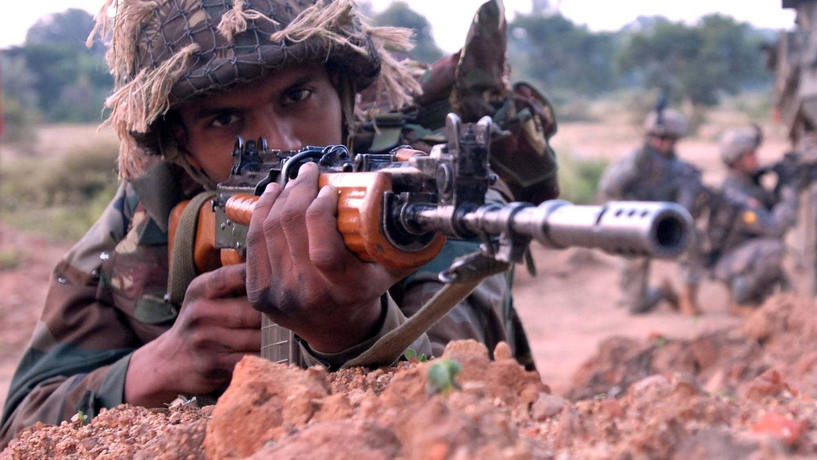 Indian Army Man Holding A Rifle Wallpaper