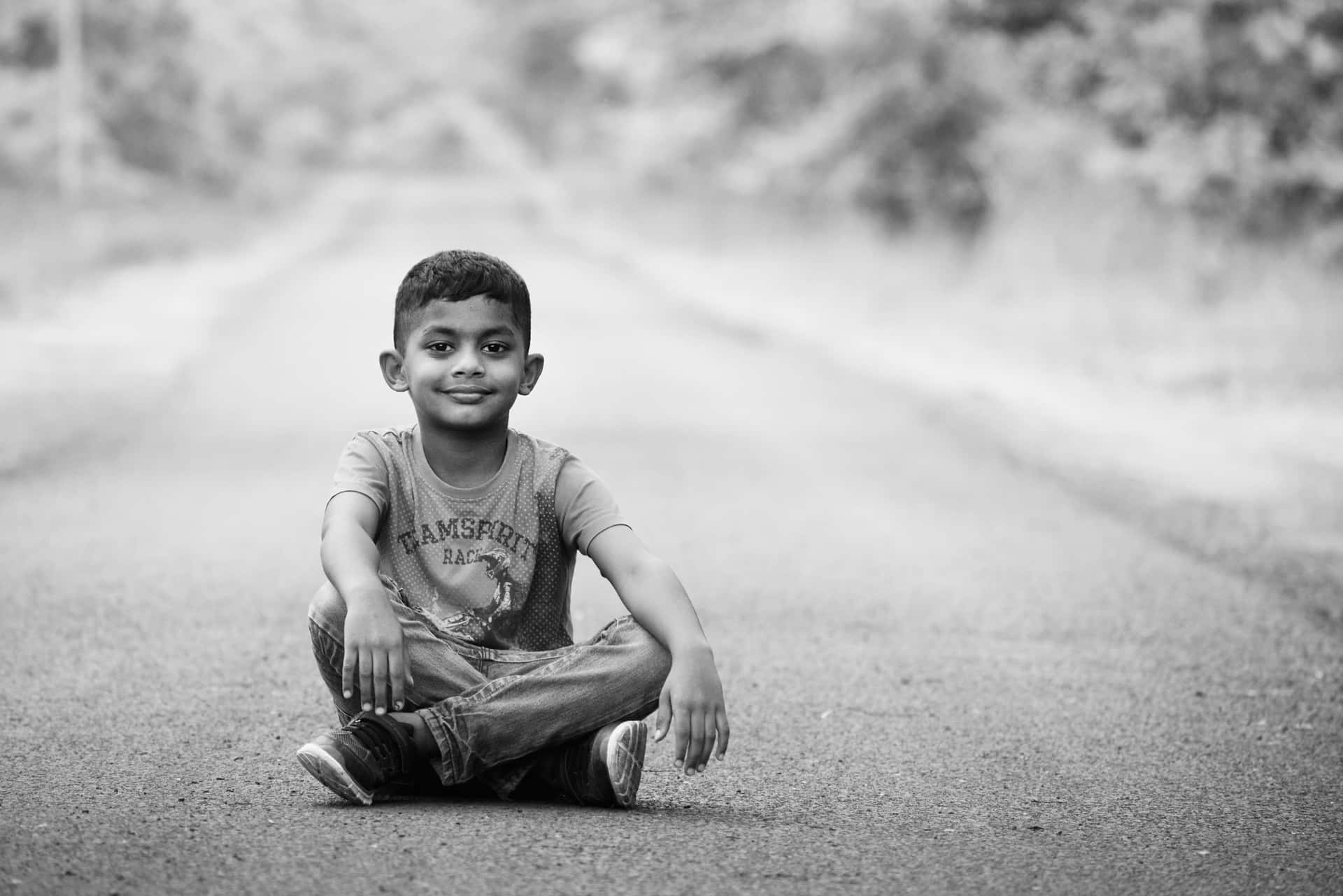 Indian Boy Sitting On The Road Picture