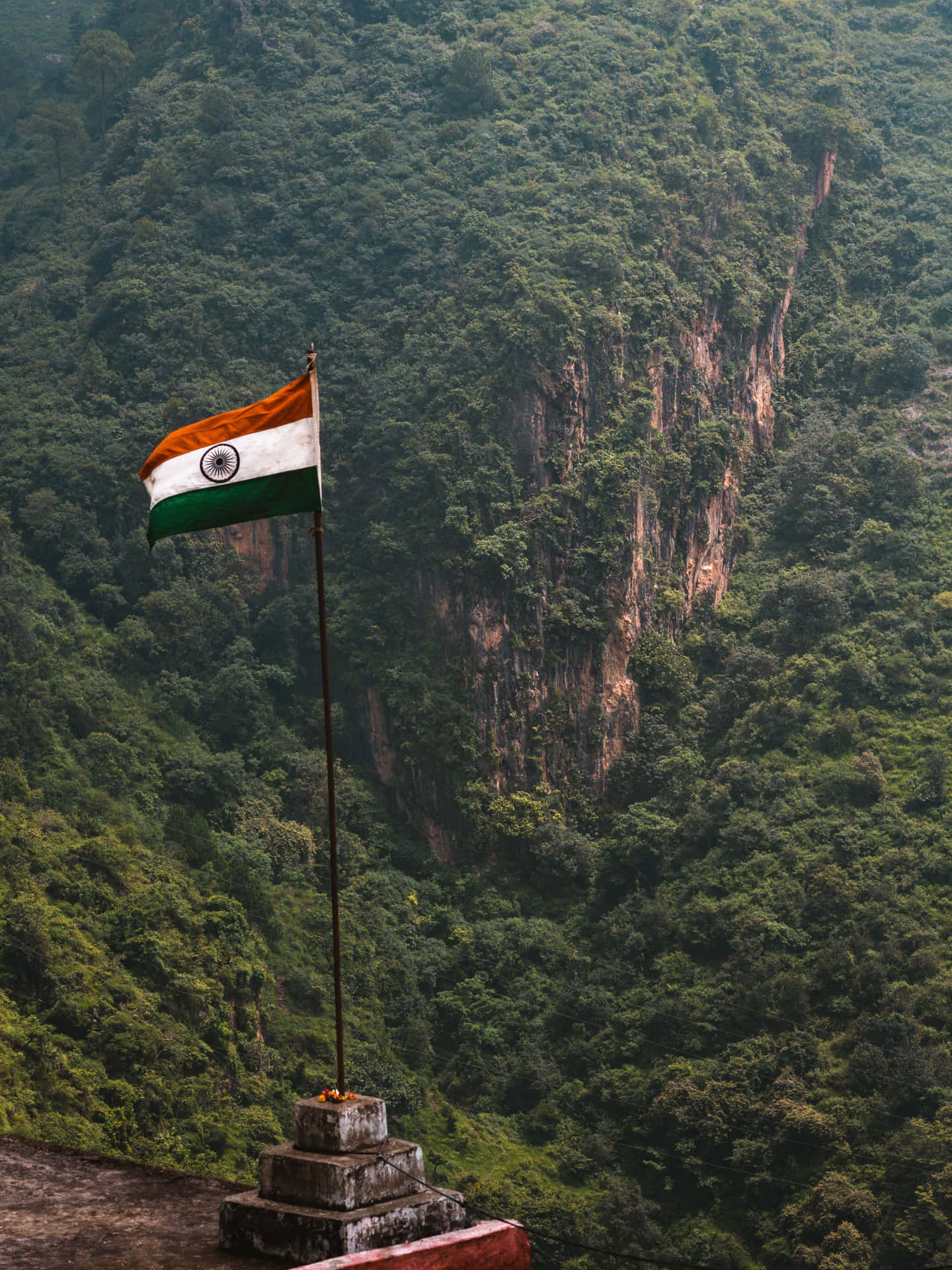 An Indian Flag Is Flying Over A Mountain