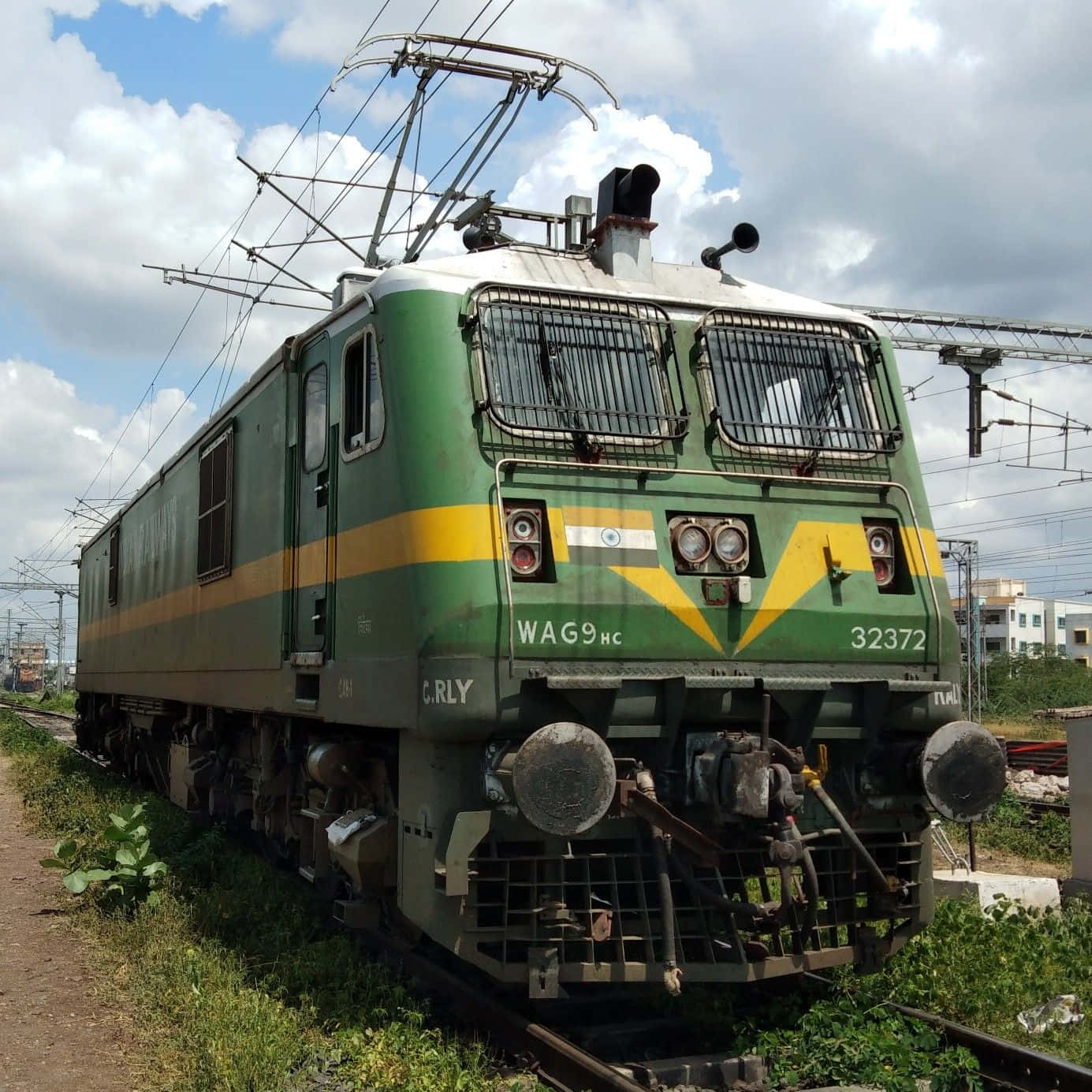 A Green And Yellow Train On The Tracks