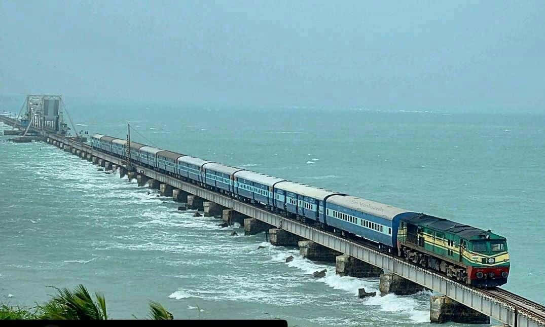A Train Traveling On A Bridge Over The Ocean
