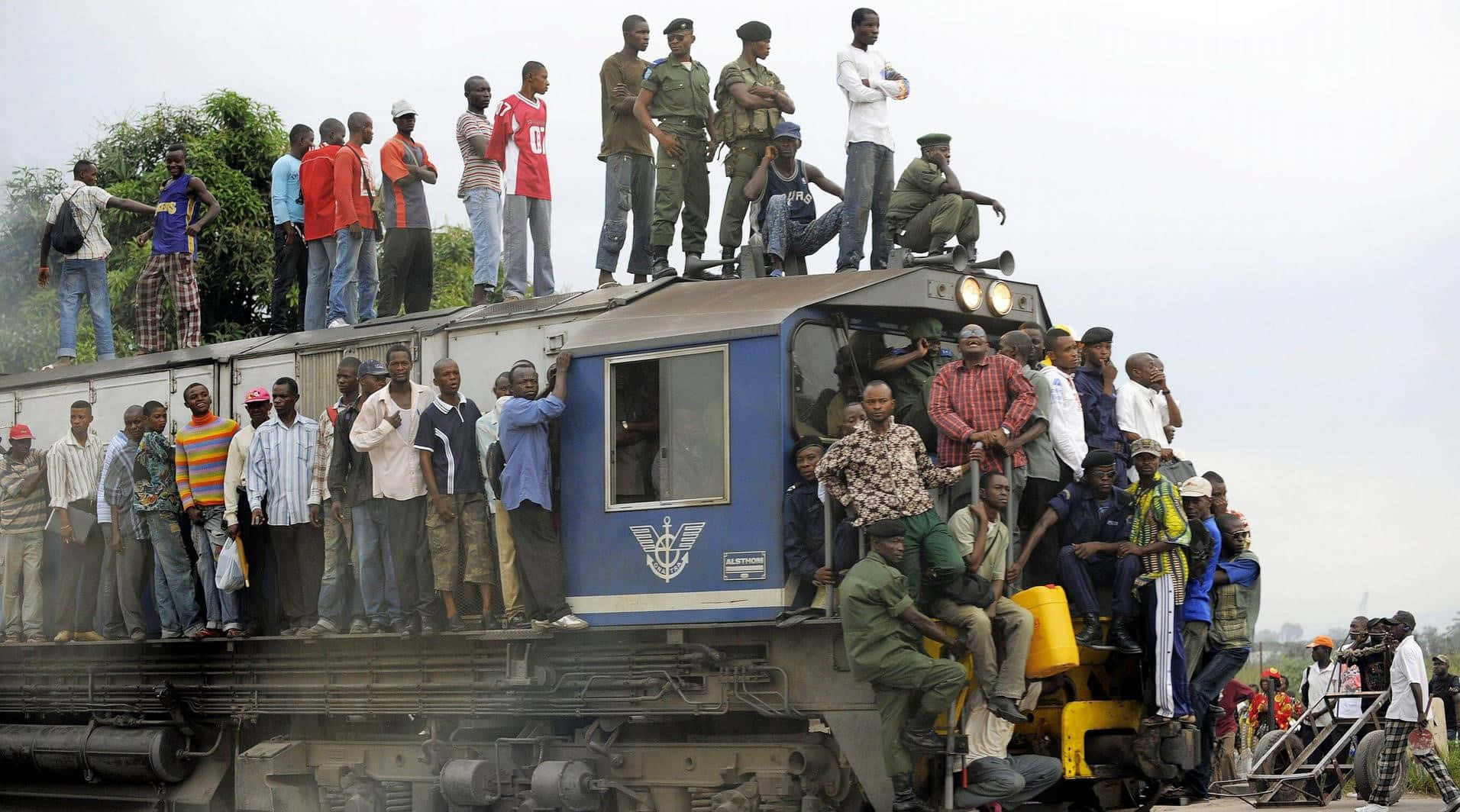 A Group Of People Standing On Top Of A Train