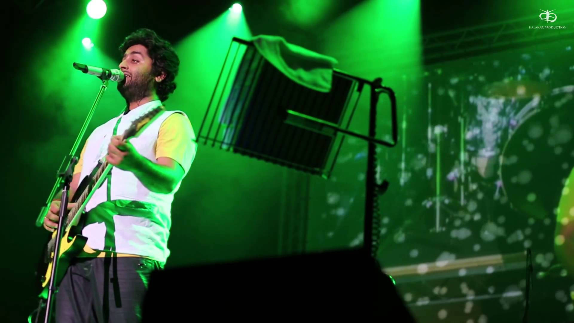 Indian Singer Arijit Singh On A Green Stage Wallpaper