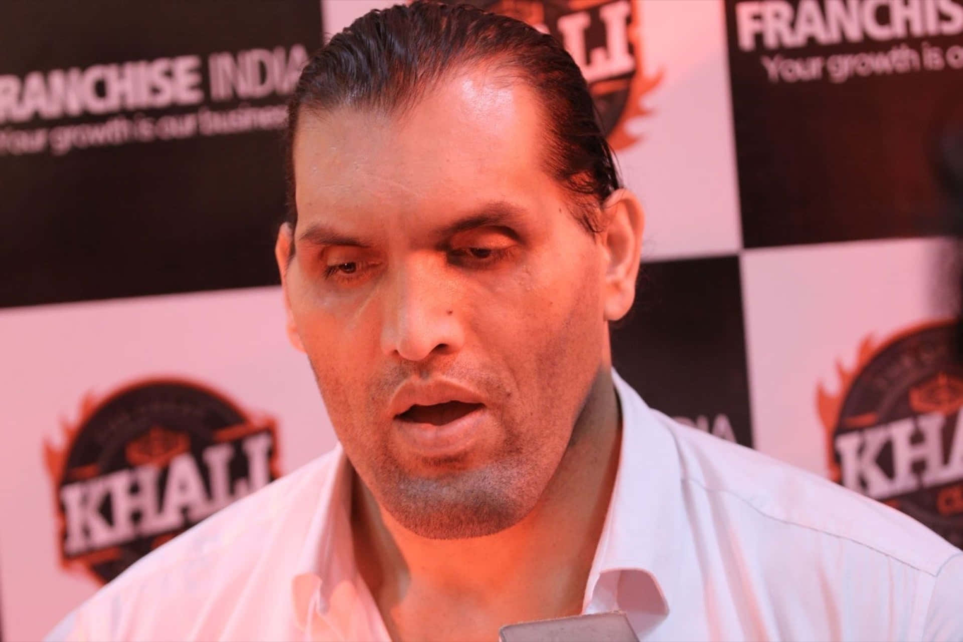 The Great Khali displays an intense expression during a wrestling match. Wallpaper