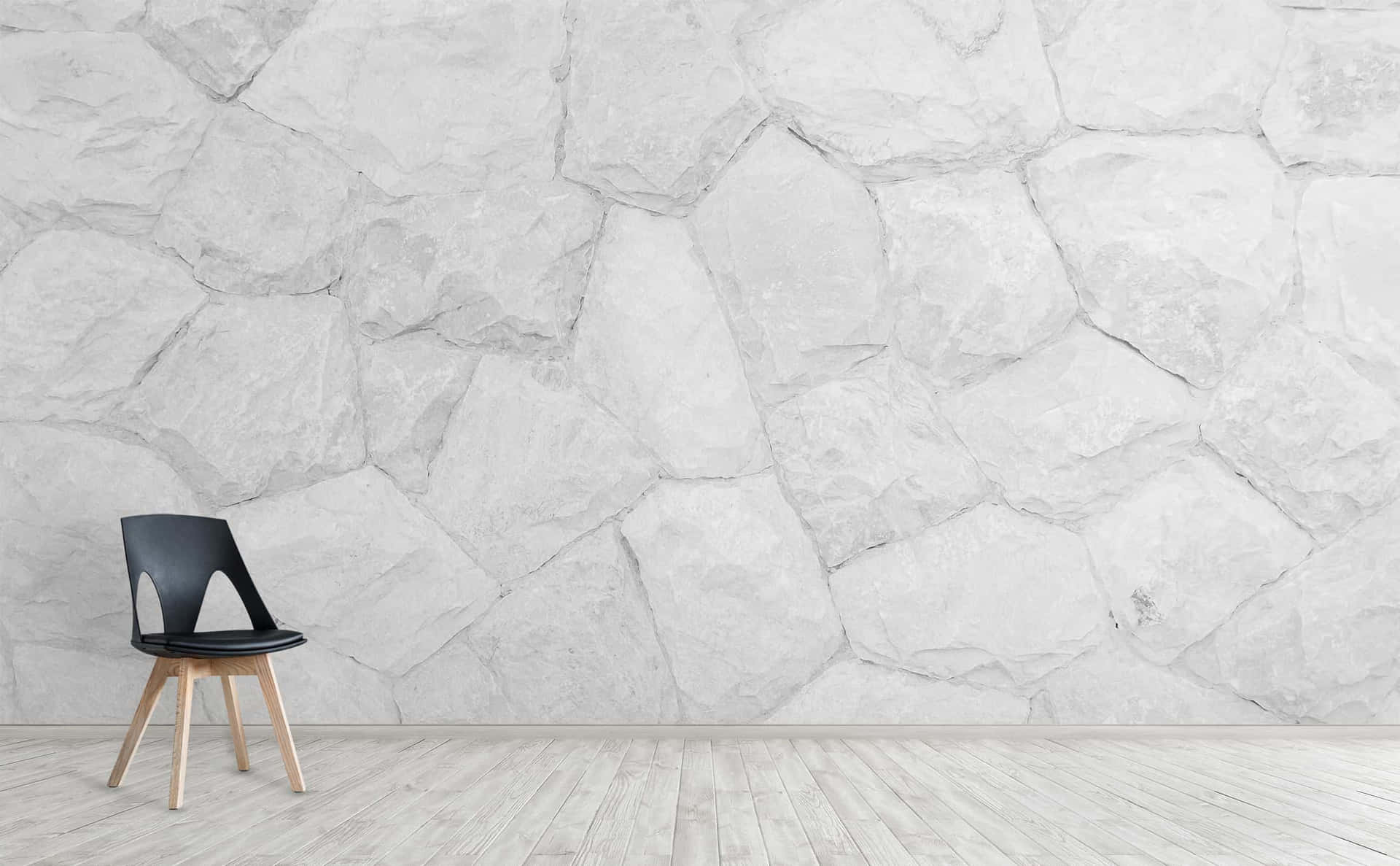 A White Stone Wall With A Chair In Front Of It