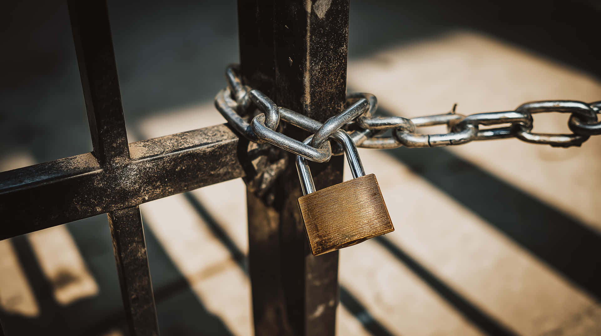 Industrial Gate Secured With Heavy Chain And Padlock Wallpaper