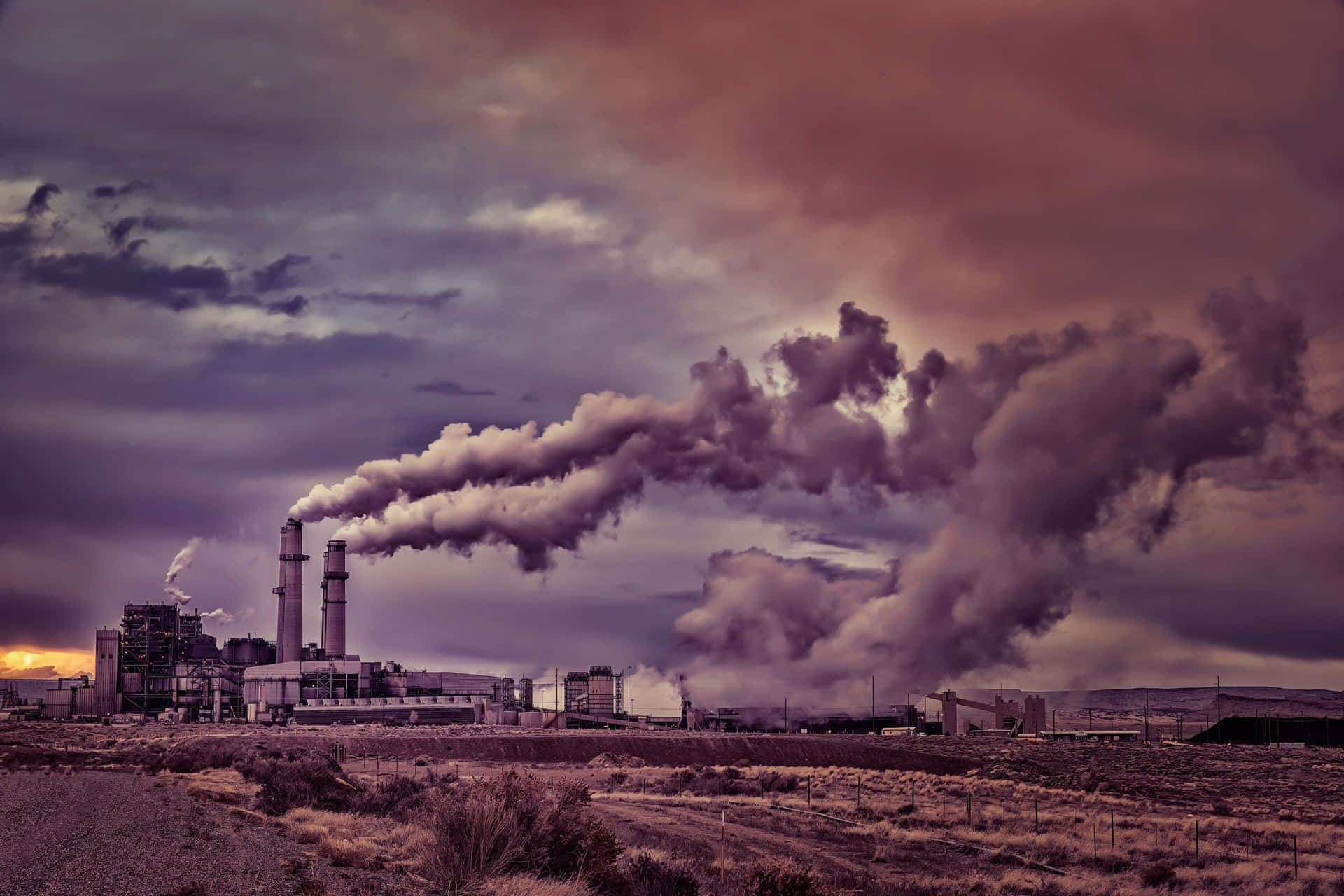 Industrial Smokestacks Emissionsat Sunset Wallpaper