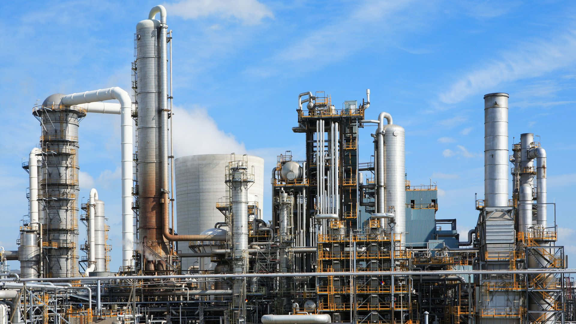 A Large Oil Refinery With Pipes And Pipes