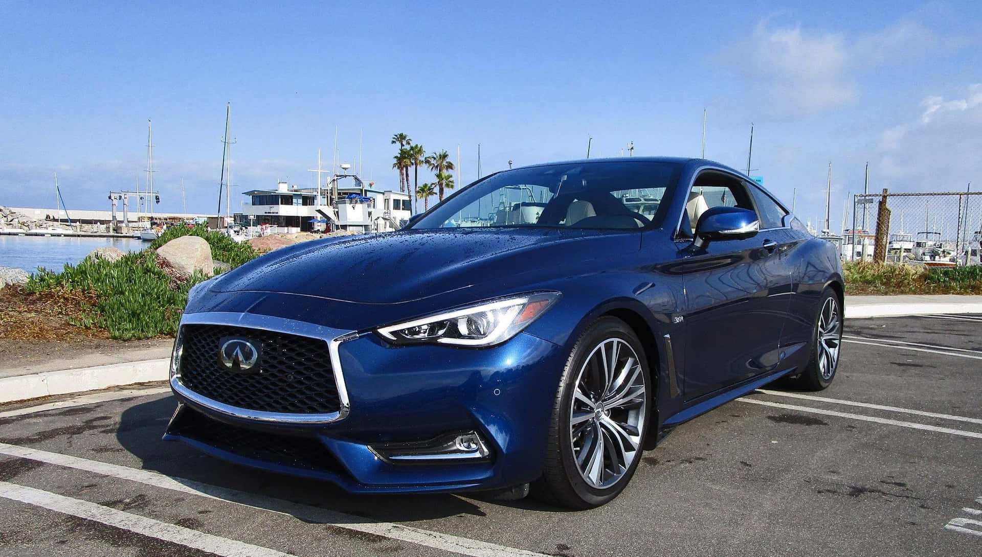 Sleek Infiniti Q60 cruising on the highway Wallpaper