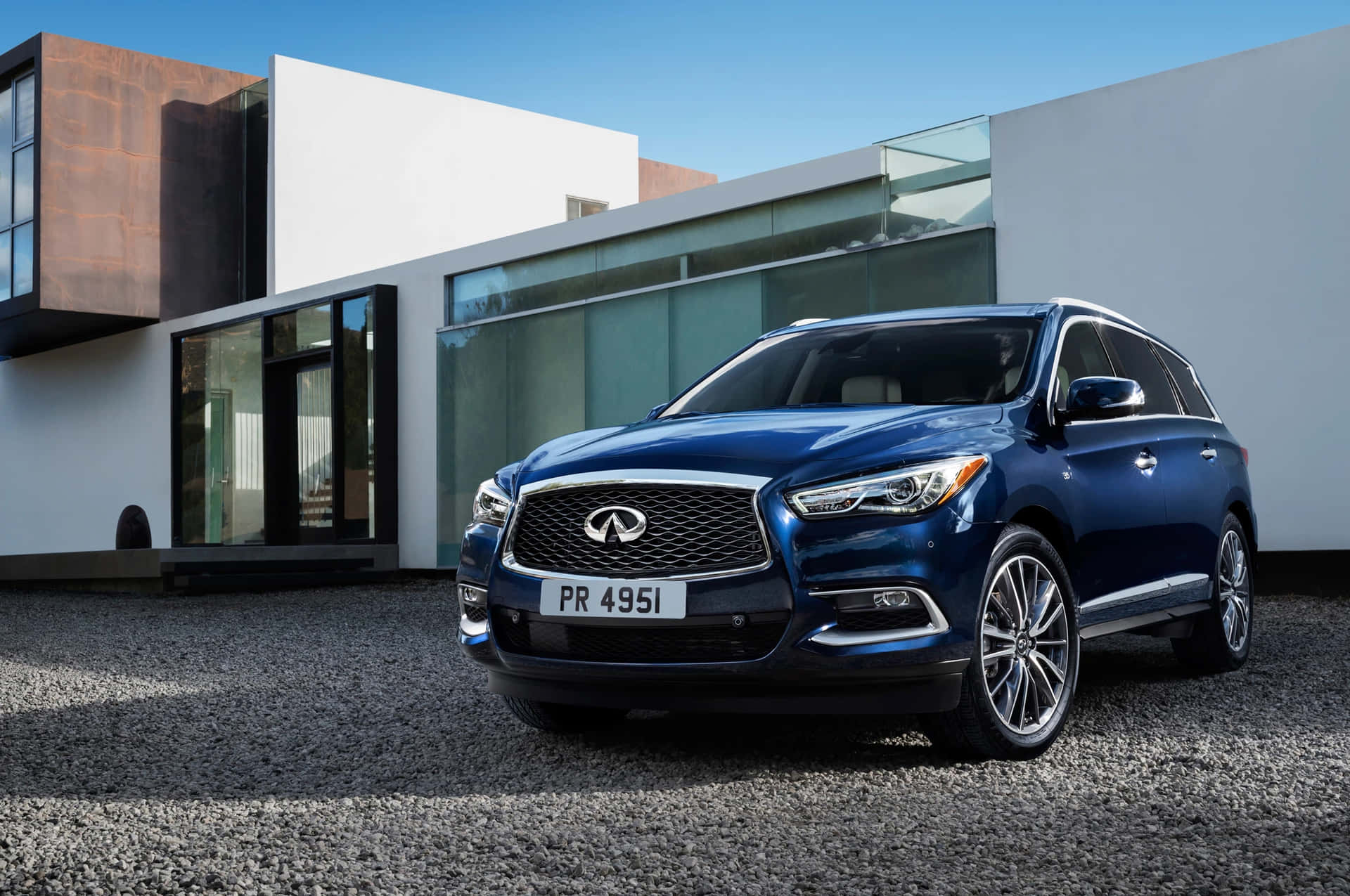 Stunning Infiniti QX60 in Motion on a Beautiful Day Wallpaper