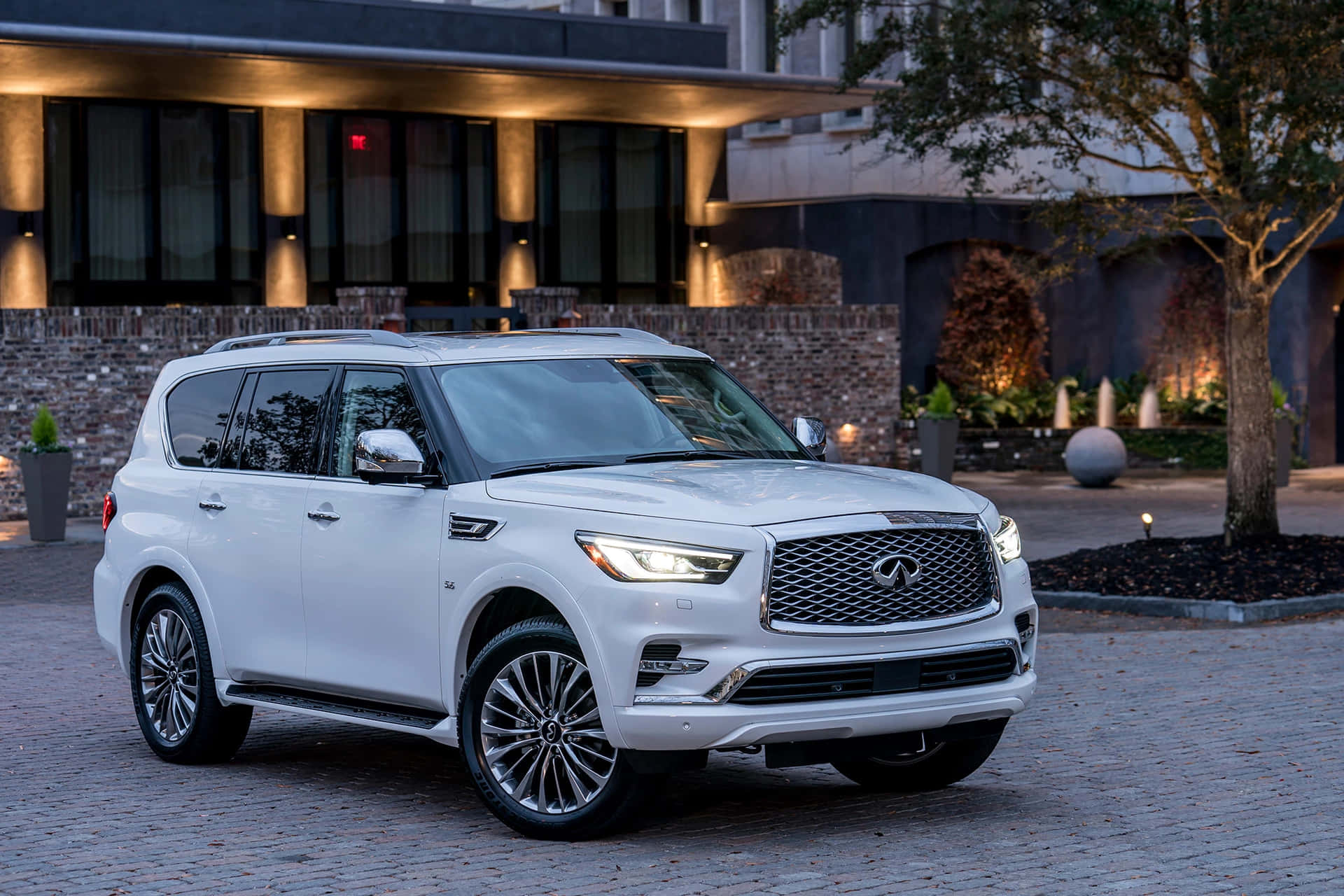 Infiniti QX80 on the road in the countryside Wallpaper