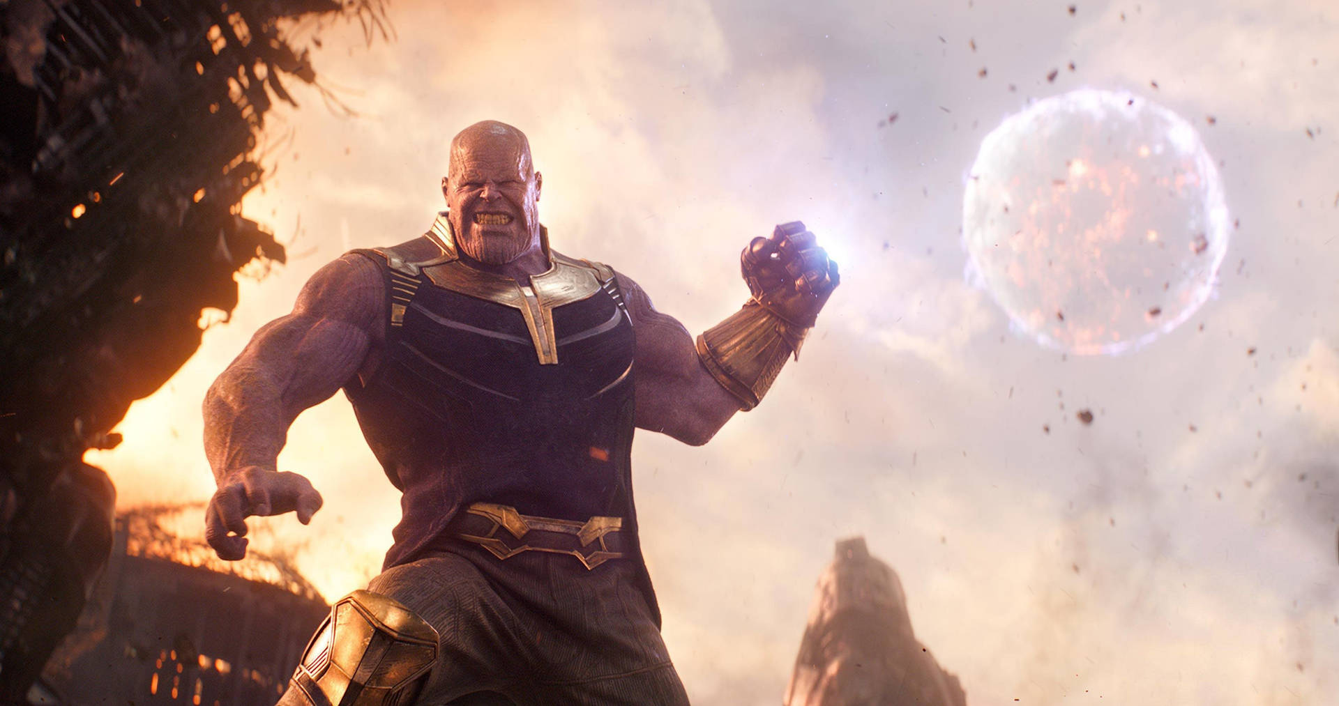 An enraged Thanos holds the Infinity Gauntlet. Wallpaper