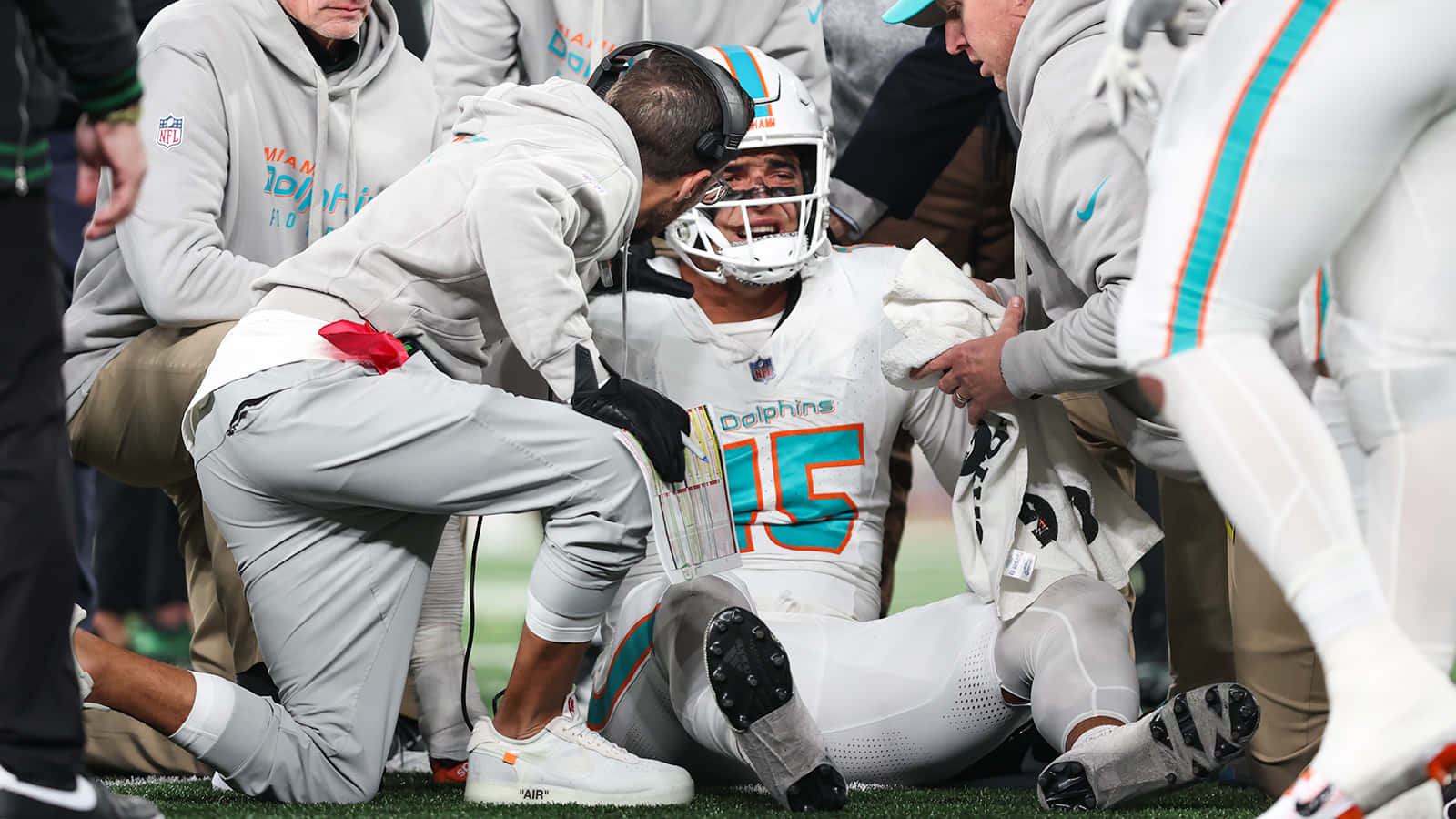 Injured Dolphins Player Consoledby Coach Wallpaper