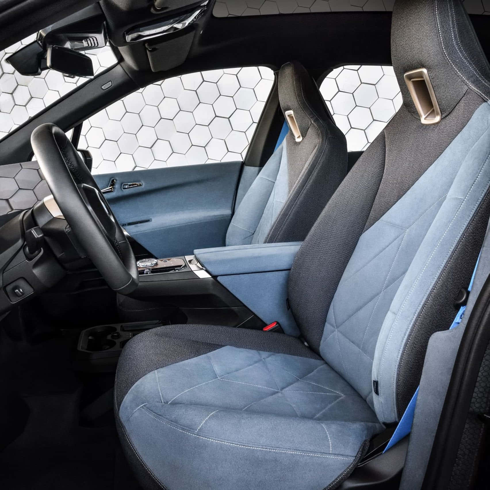 A Car With Blue Leather Seats And A Steering Wheel Wallpaper