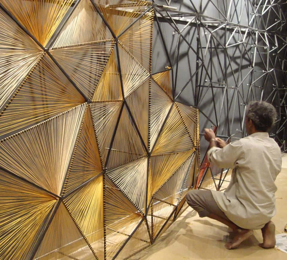An architectural installation created with reclaimed building materials constructs an orbiting shape Wallpaper