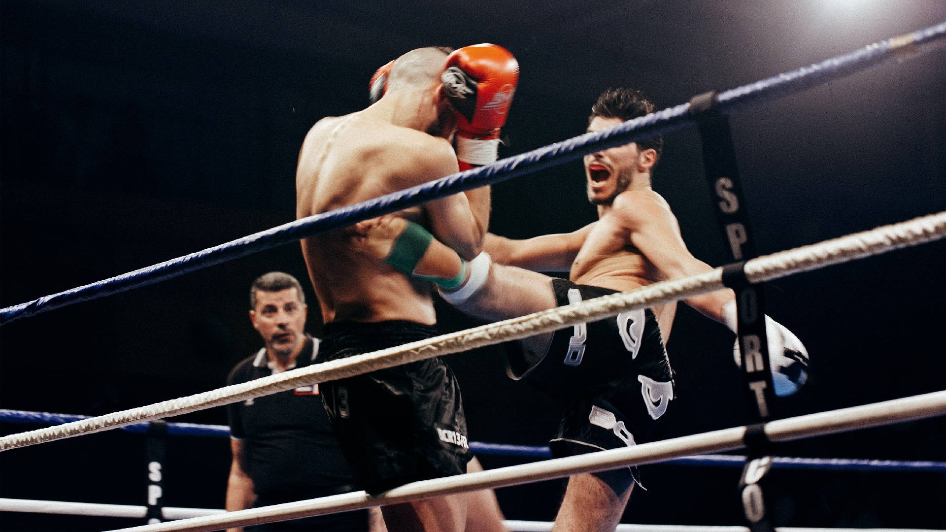 Intense Kickboxing Duel On The Ring Wallpaper