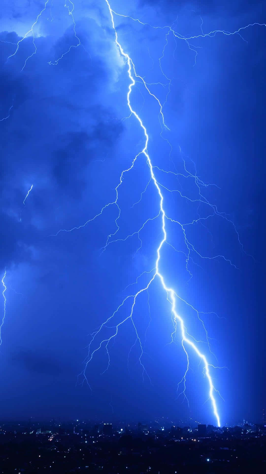 Intense Lightning Strike Over City Night Sky Wallpaper