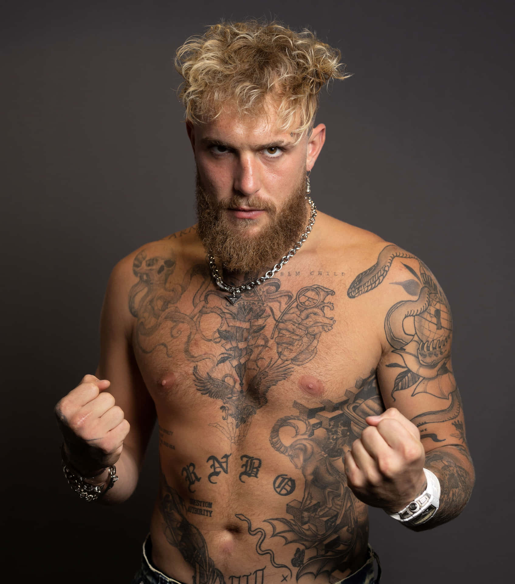 Intense Tattooed Man Readyto Fight Wallpaper