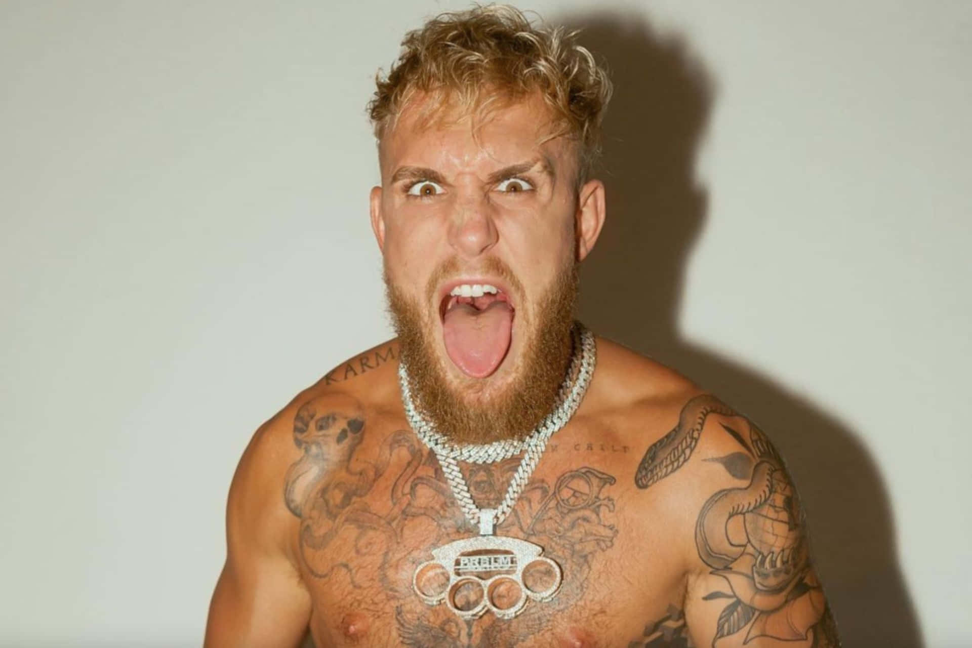 Intense Tattooed Man Yelling Wallpaper