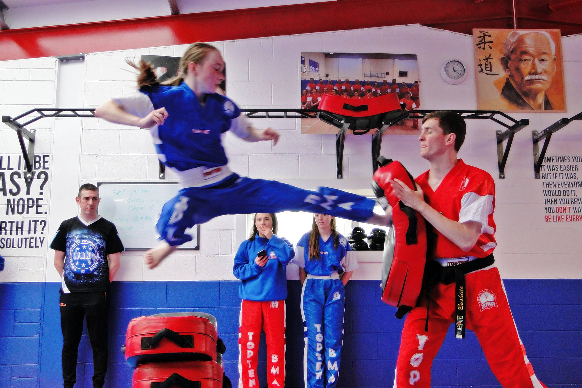 Empowered Woman during Intensive Kickboxing Training Wallpaper