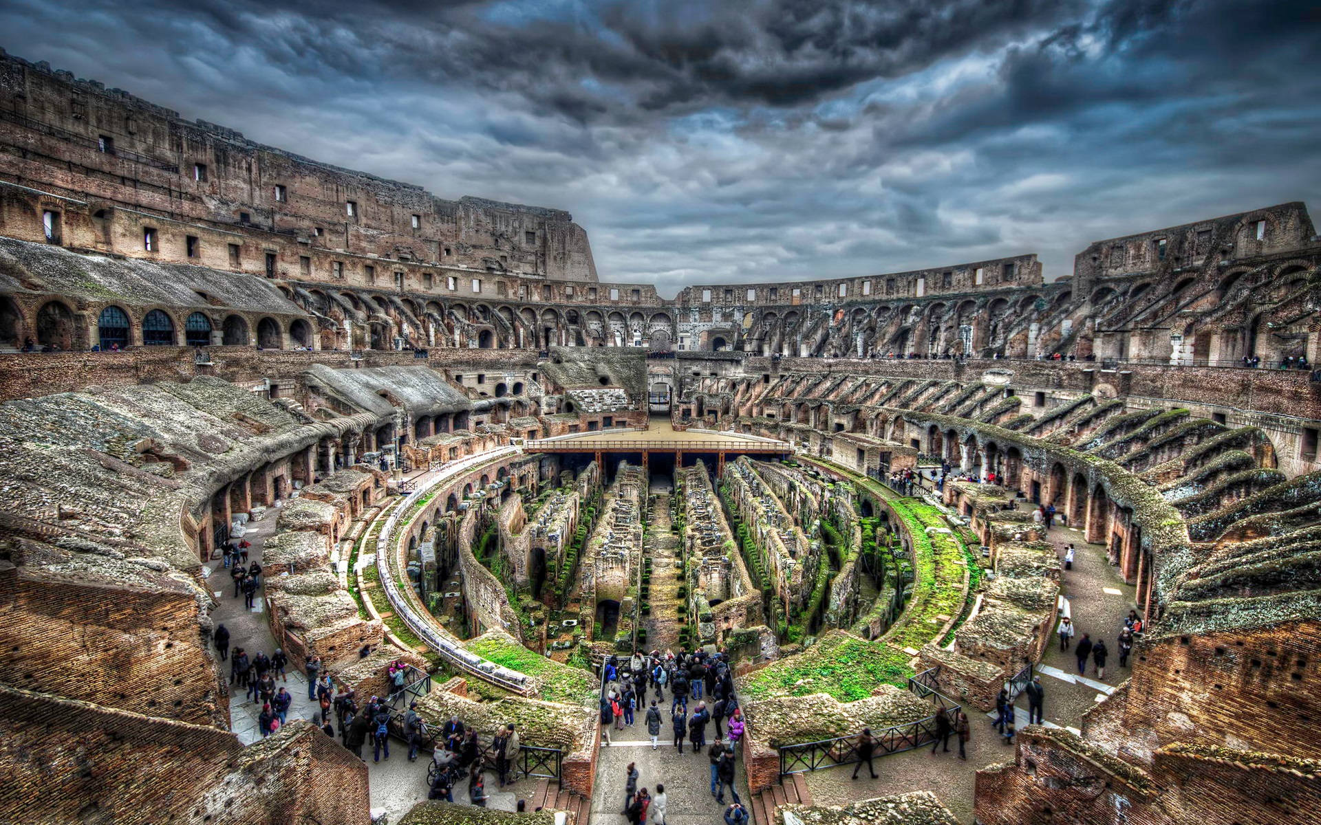 Interior Of The Colosseum Beneath A Dark Sky Wallpaper