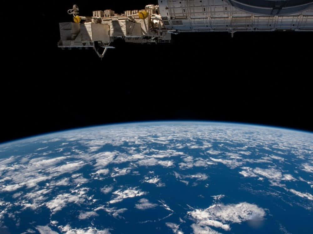 A view of the International Space Station orbiting Earth Wallpaper