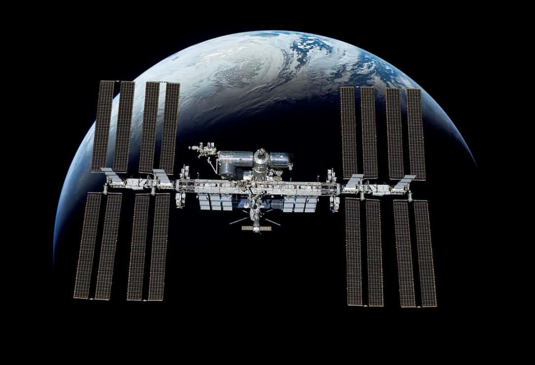 Majestic International Space Station Orbiting Earth Wallpaper
