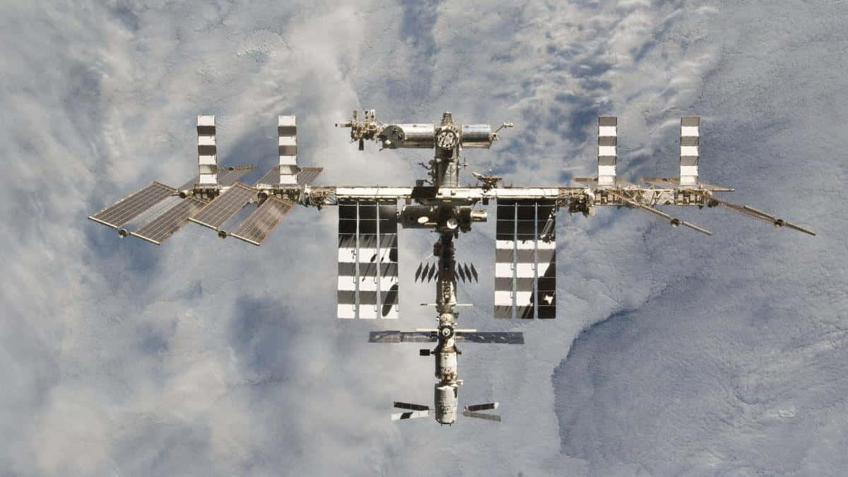 A breathtaking view of the International Space Station orbiting Earth Wallpaper
