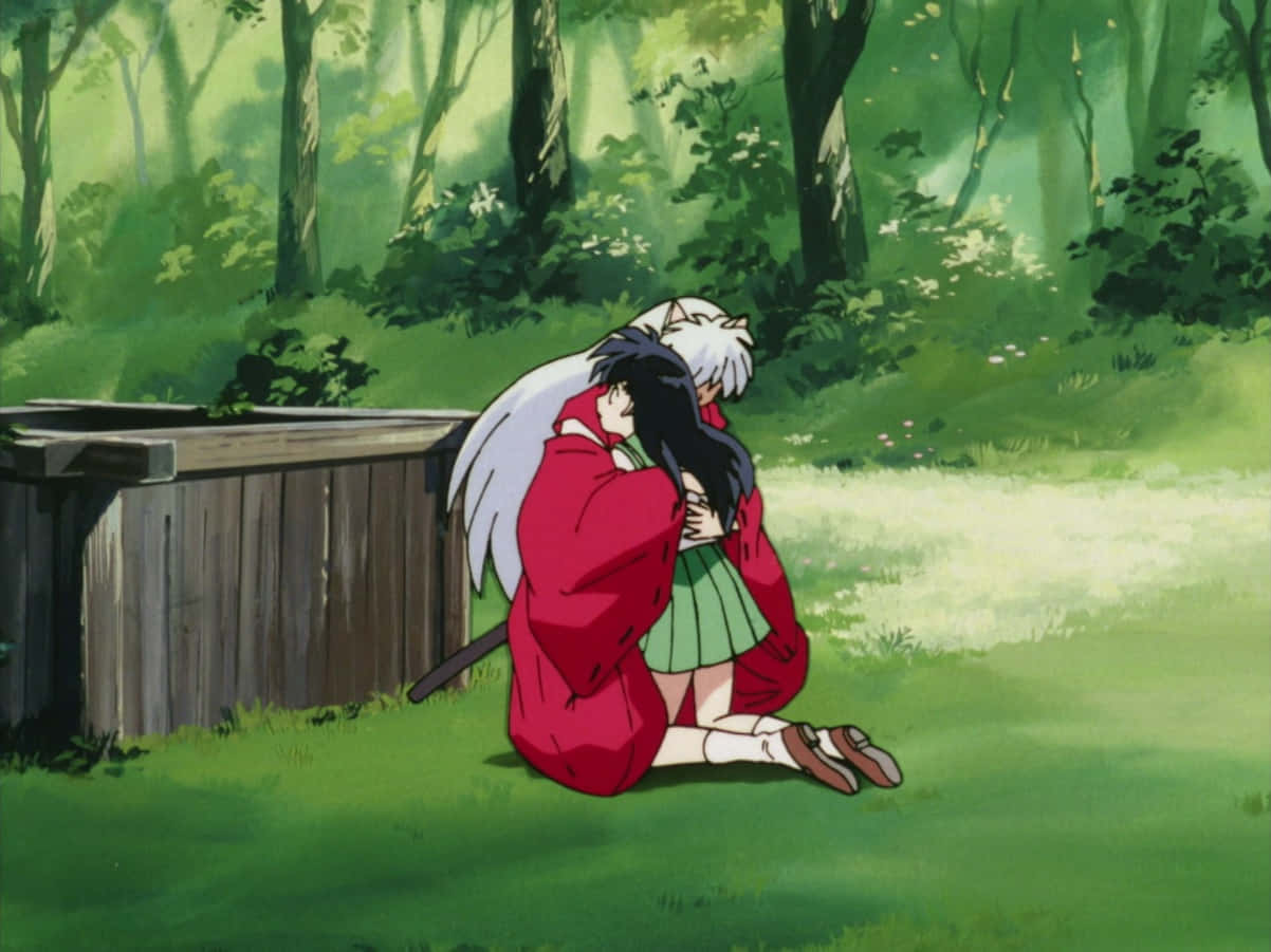 Inuyasha and Kagome sharing a tender moment in a serene setting Wallpaper