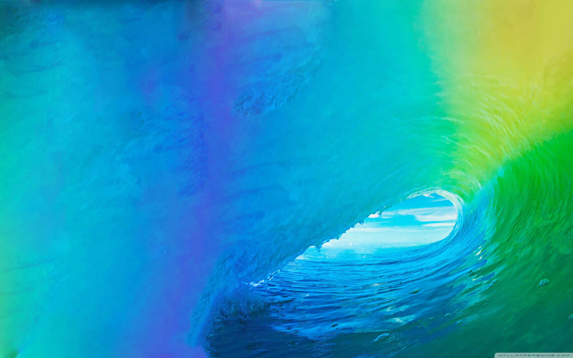 A Rainbow Colored Wave In The Ocean Wallpaper