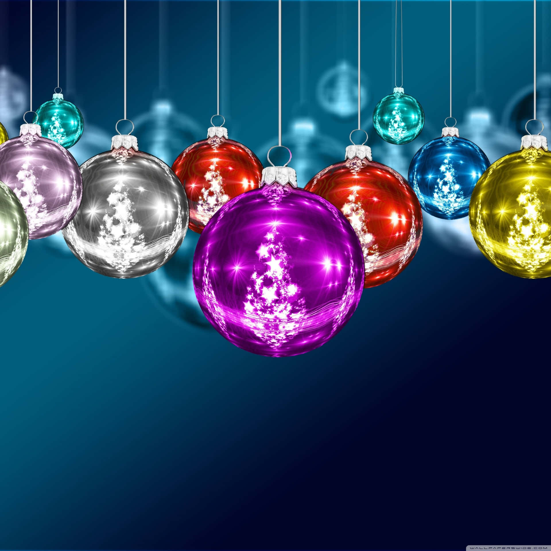 Christmas Ornaments Hanging From Strings On A Blue Background Wallpaper