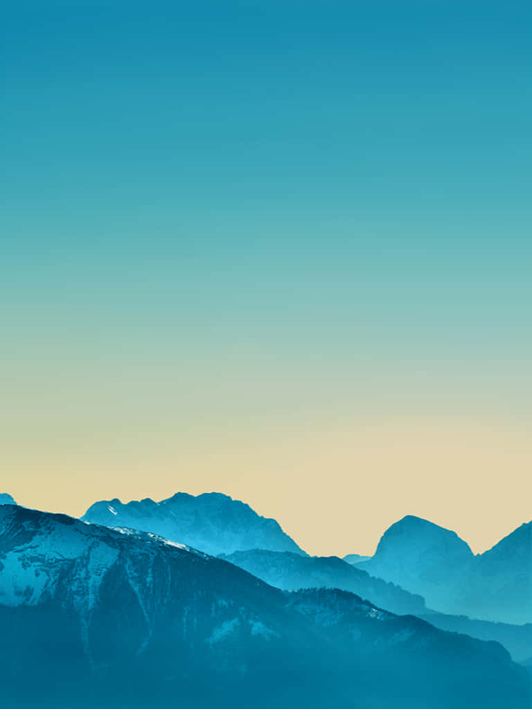 A Blue Sky With Mountains In The Background Wallpaper