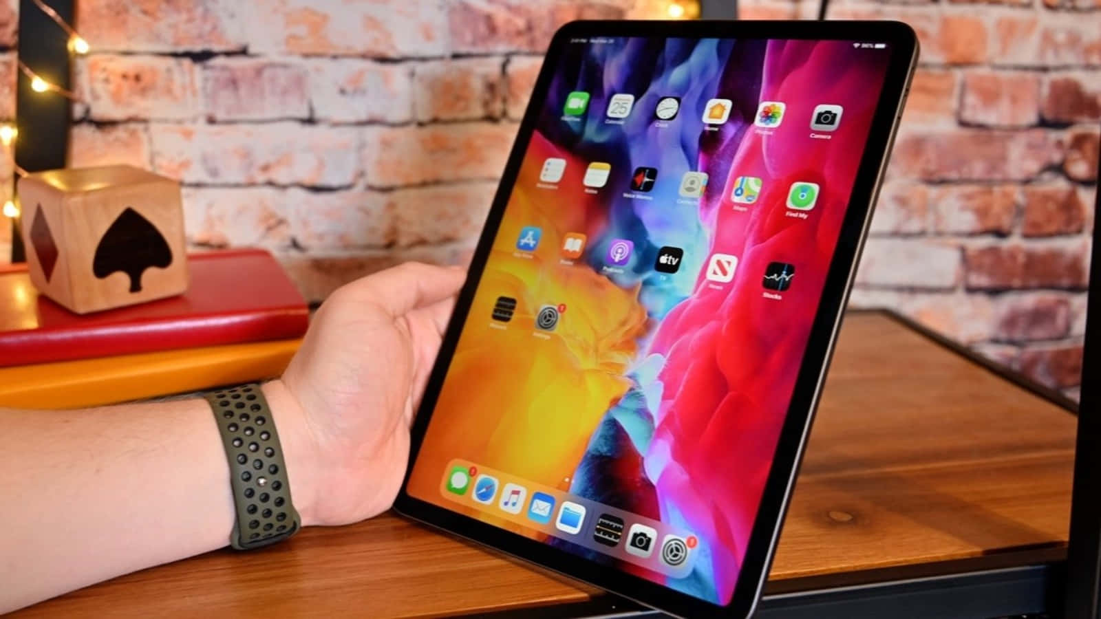 A Person Holding An Apple Ipad Pro With A Screen