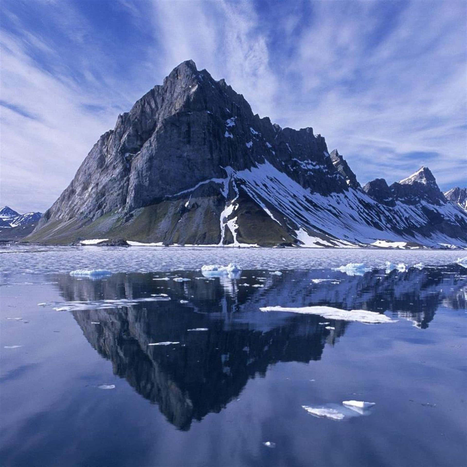 A Mountain Is Reflected In The Water
