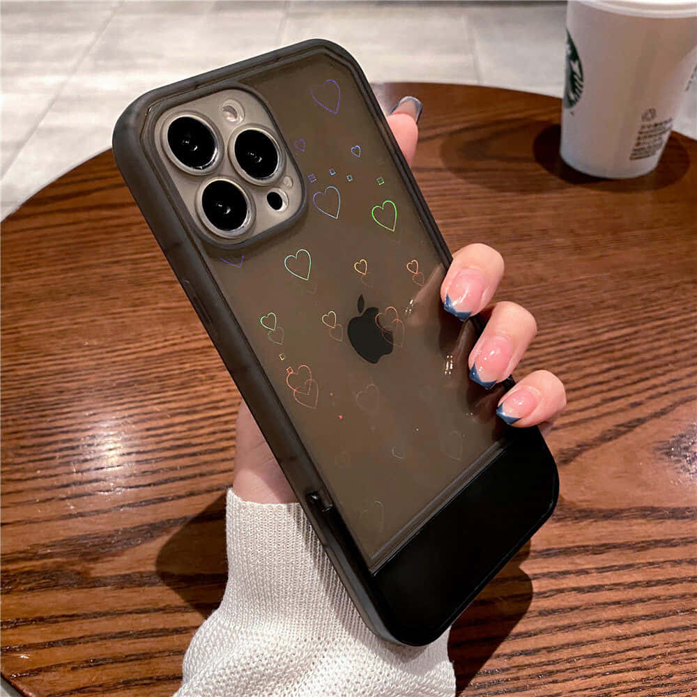 A Woman Holding An Iphone 11 Case With Hearts On It