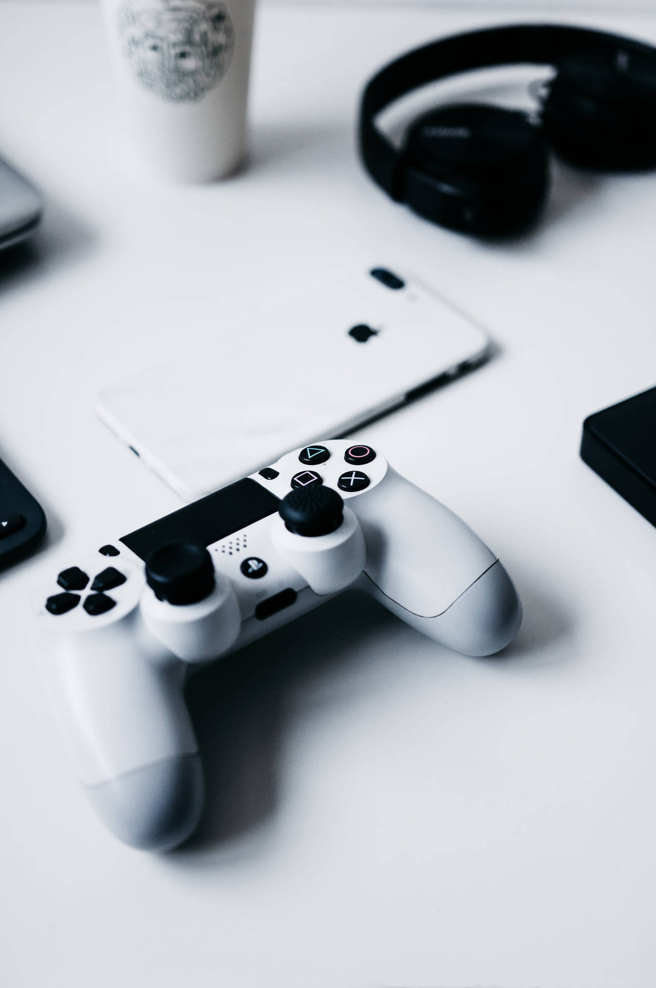 Iphone Desk With Playstation Controller Wallpaper