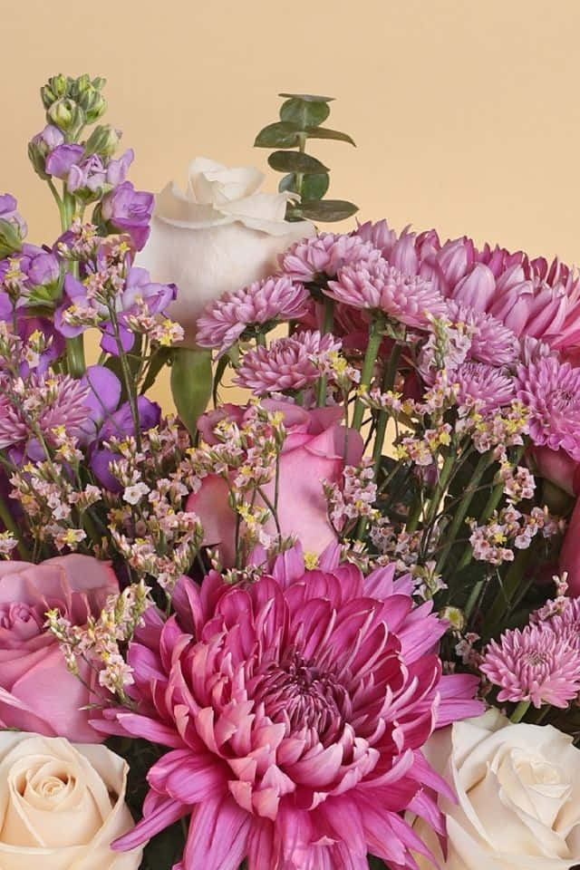 A Pink And White Bouquet Of Flowers Is Shown