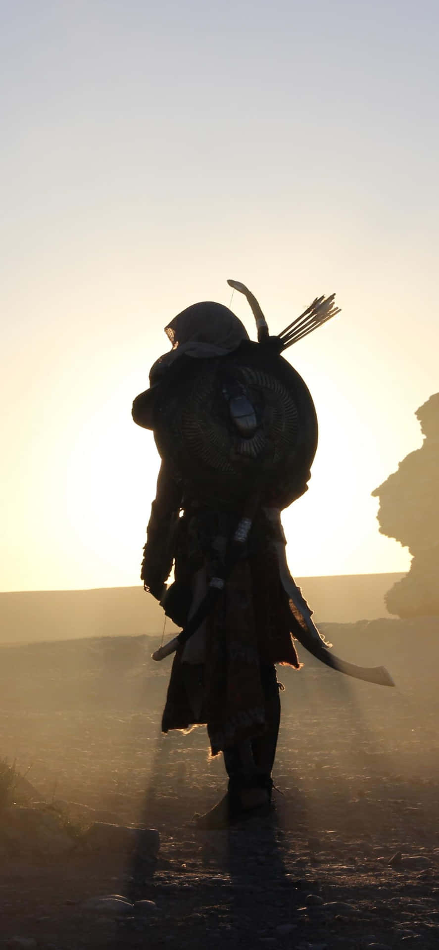 A Man In A Robe Is Walking In The Desert