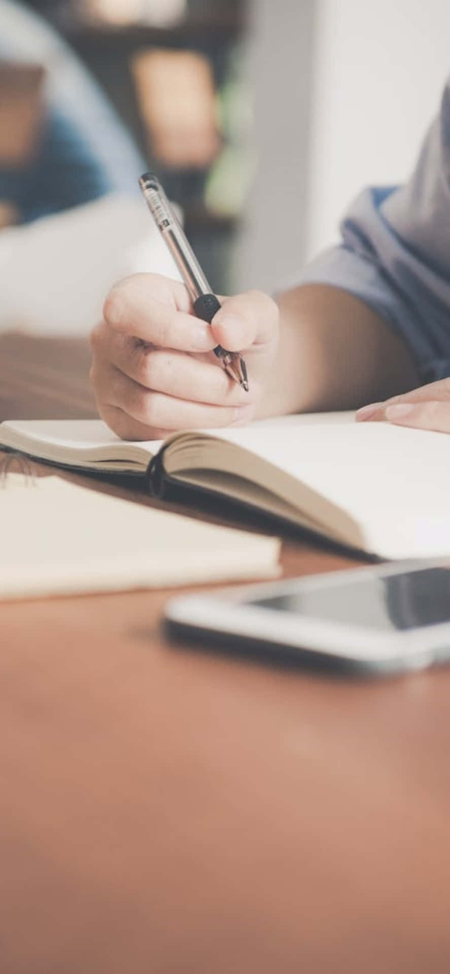 Iphone X Desk Background Person Writing On A Notebook