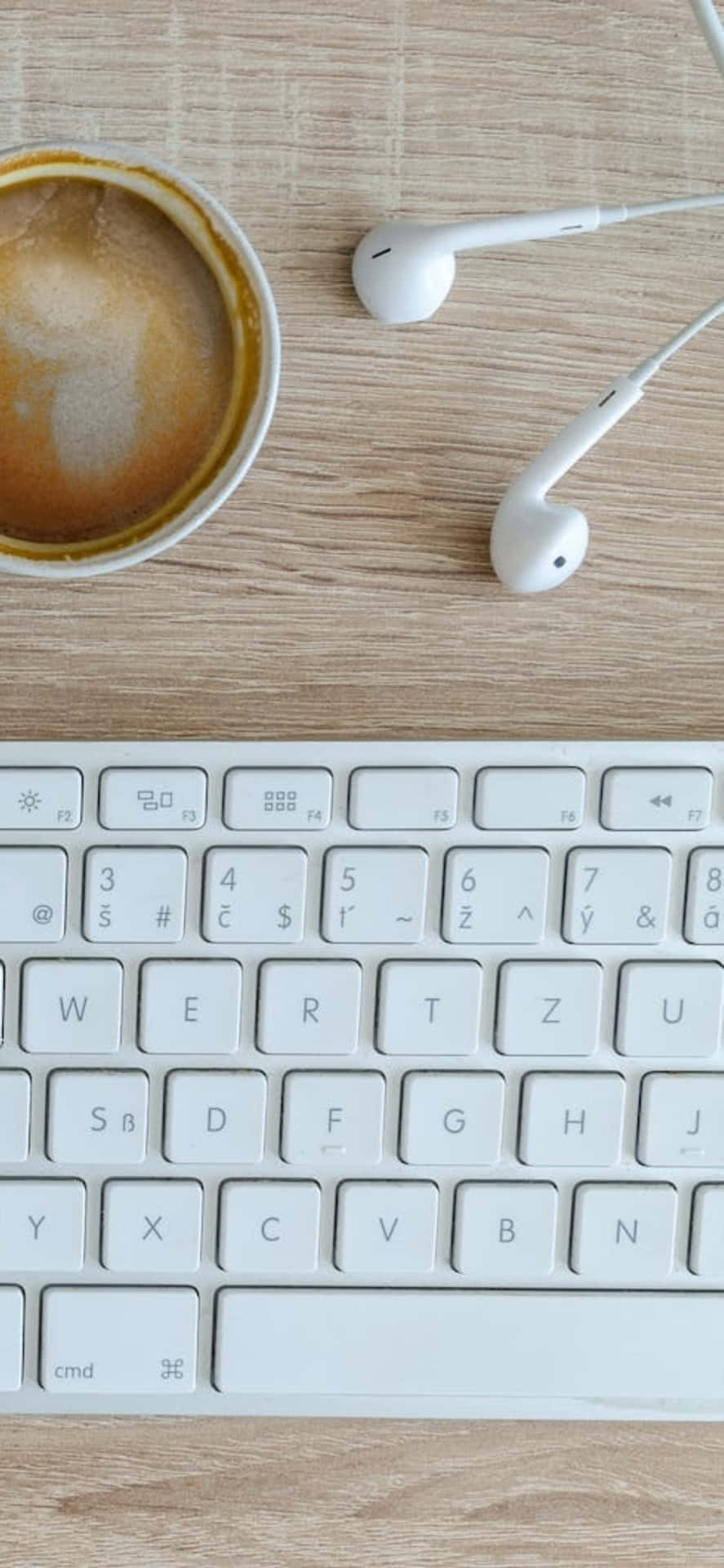 Iphone X Desk Background Earphones And A Keyboard